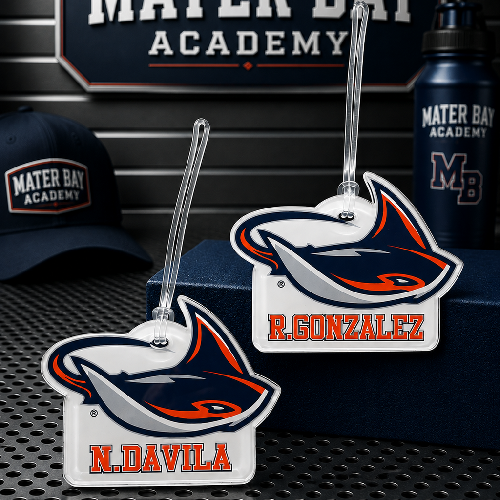 Two Mater Bay Academy luggage tags featuring the school's shark mascot, with personalized names 'R. GONZALEZ' and 'N.