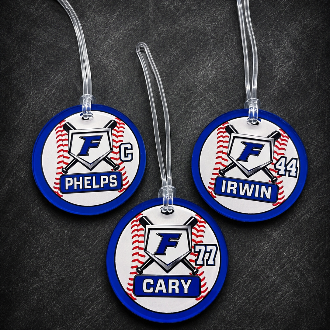 Three round tags with names and numbers on a dark background