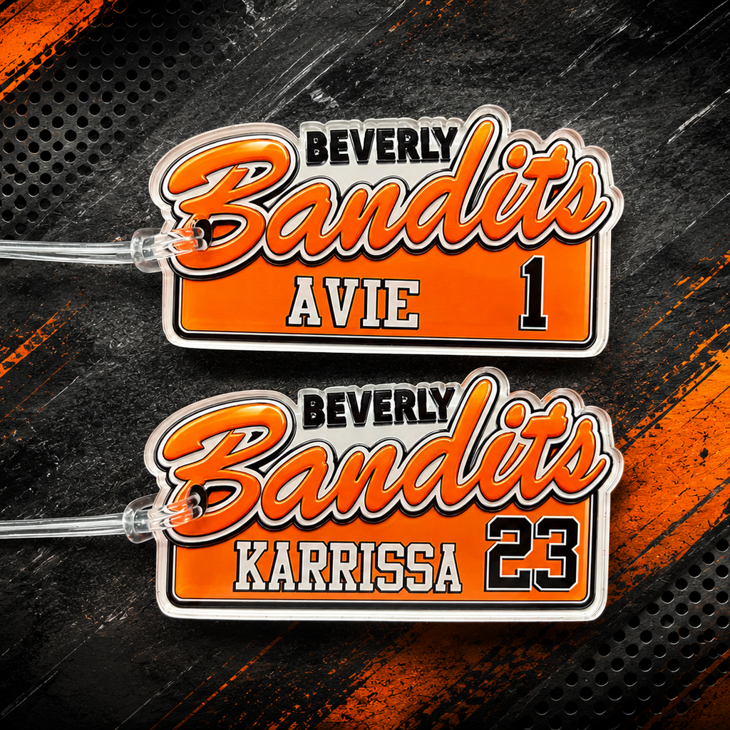 Two custom sports team patches for the Beverly Bandits, featuring orange and white lettering with black outlines, displayed on a dark textured background with orange brushstroke accents.